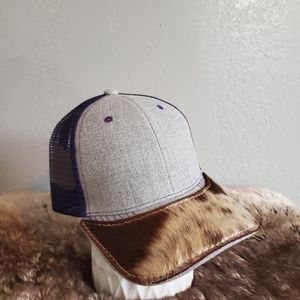 Ball cap with hand-sewn leather cowhide patch on brim